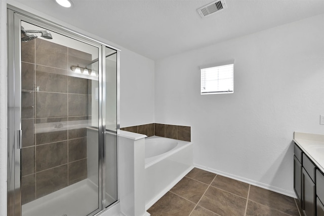 bathroom featuring tile floors, separate shower and tub, and vanity