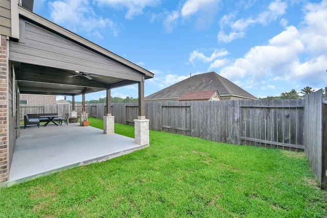 view of yard with ceiling fan and a patio