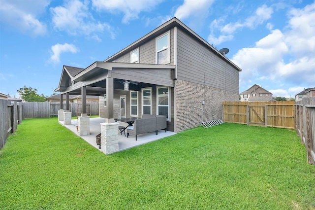 back of house featuring ceiling fan, a lawn, a patio area, and an outdoor living space