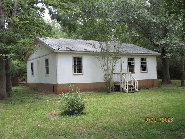 back of property featuring a lawn