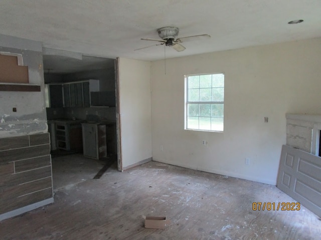 unfurnished living room featuring ceiling fan