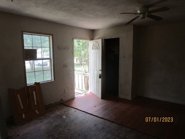 unfurnished room with hardwood / wood-style floors, a wealth of natural light, and ceiling fan