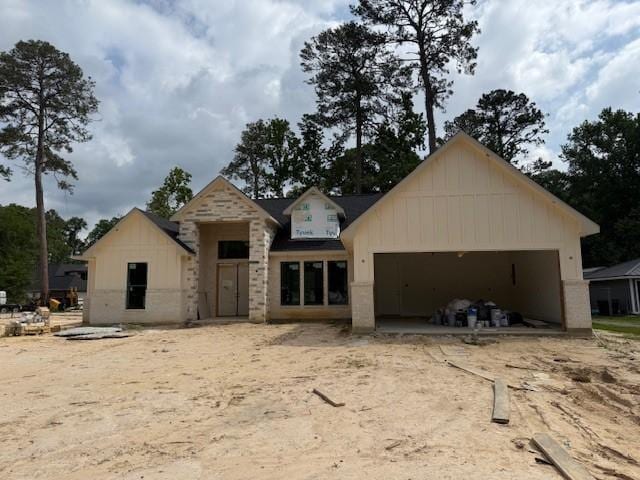 2723 Michaelangelo St, New Caney, TX 77357 - rear view of house featuring a garage and board and batten siding