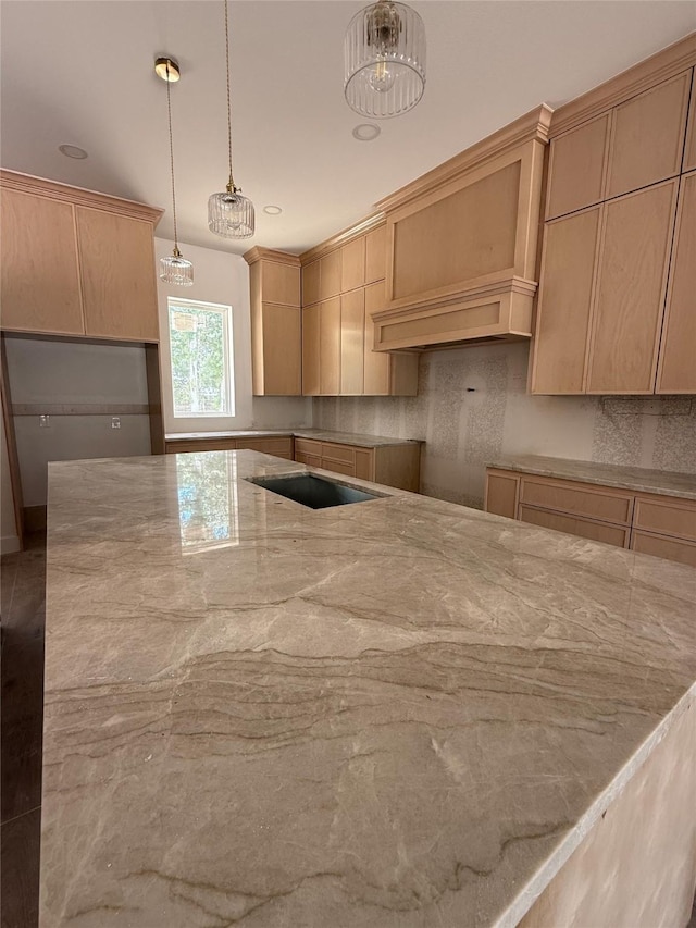 2723 Michaelangelo St, New Caney, TX 77357 - kitchen with light stone counters, decorative backsplash, and pendant lighting