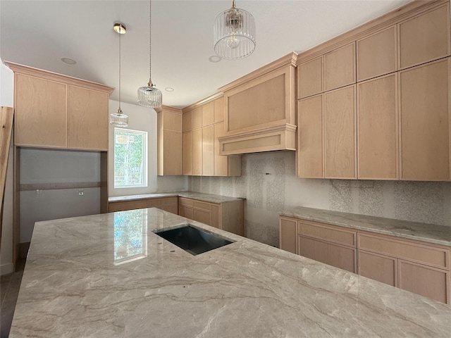 2723 Michaelangelo St, New Caney, TX 77357 - kitchen featuring light stone countertops, decorative backsplash, hanging light fixtures, and light brown cabinets
