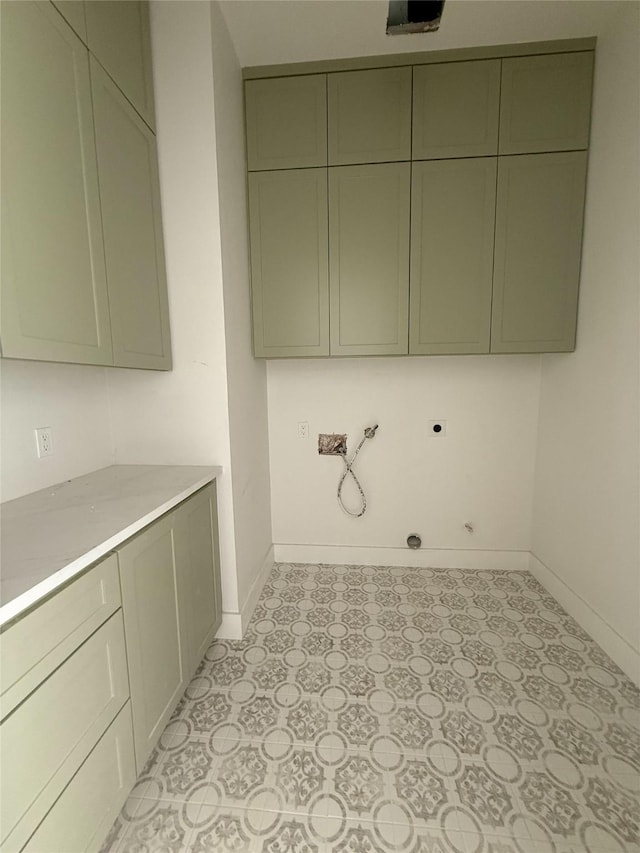2723 Michaelangelo St, New Caney, TX 77357 - laundry area featuring cabinet space, hookup for an electric dryer, hookup for a washing machine, and light flooring