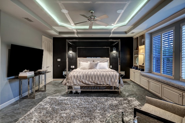 tiled bedroom featuring a tray ceiling and ceiling fan