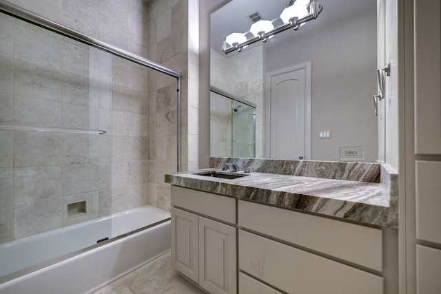 bathroom with combined bath / shower with glass door, tile flooring, and oversized vanity