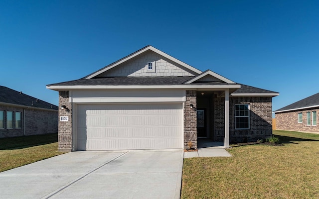 view of front of house with a front yard and a garage