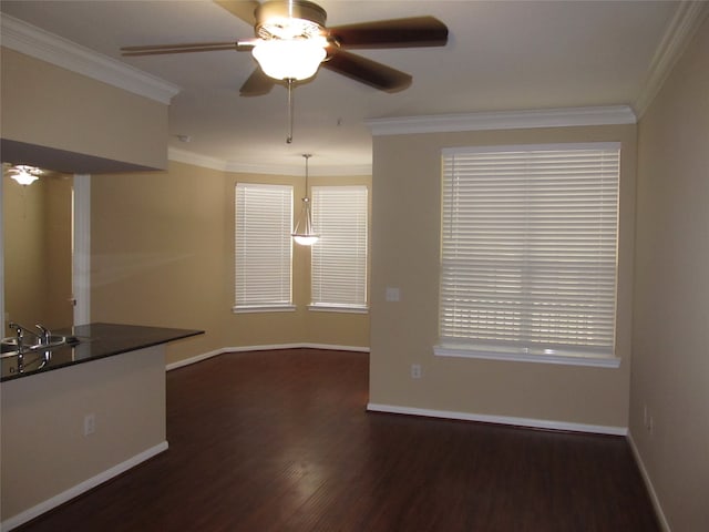 spare room featuring ornamental molding, dark hardwood / wood-style flooring, ceiling fan, and sink