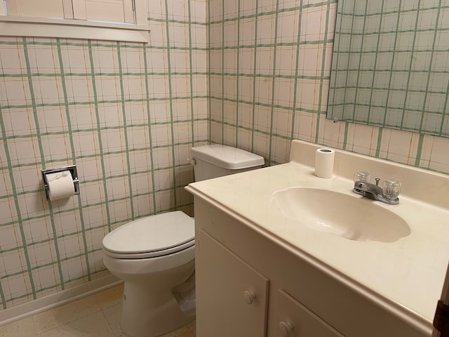 bathroom with tile walls, tile flooring, oversized vanity, and toilet