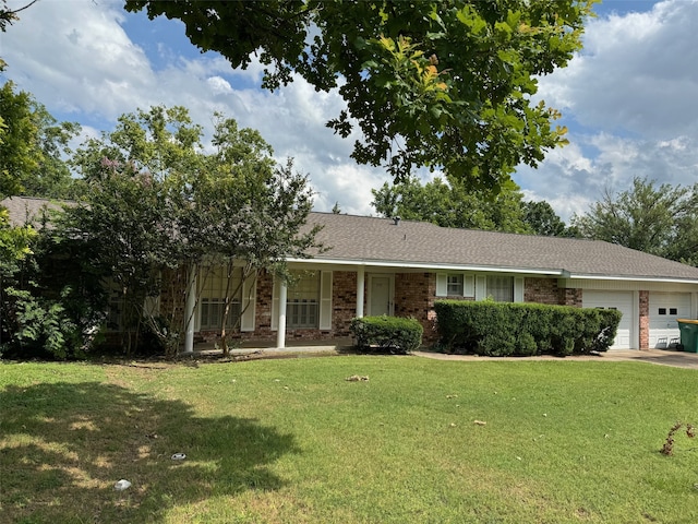 ranch-style house featuring a front yard and a garage