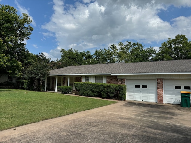 ranch-style home featuring a garage and a front yard