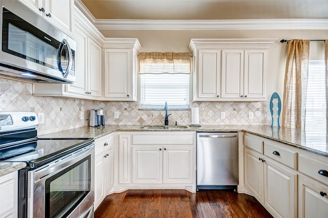 kitchen featuring sink, stainless steel appliances, light stone counters, and dark hardwood / wood-style floors