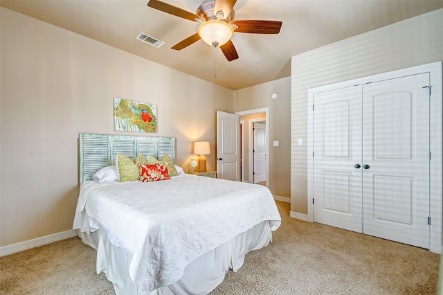 bedroom with a closet, light colored carpet, and ceiling fan