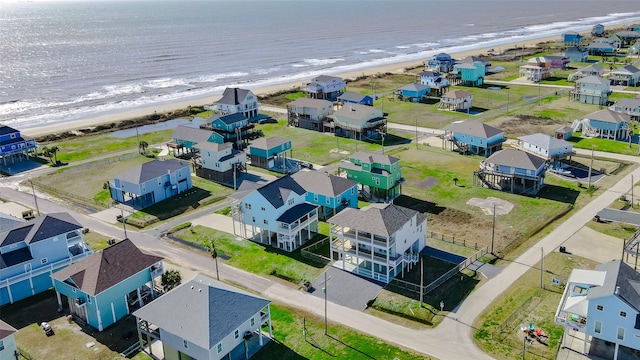 birds eye view of property featuring a beach view and a water view