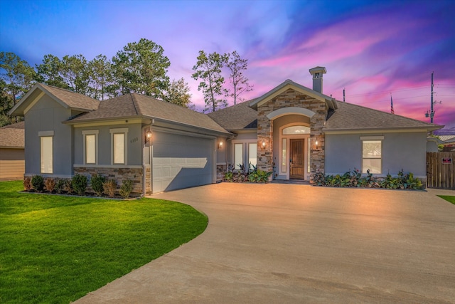 view of front of home with a lawn and a garage