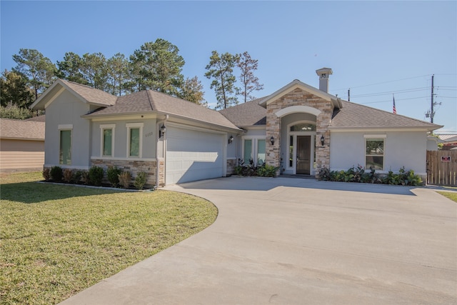 view of front of house with a front yard and a garage