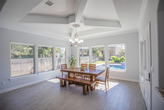 dining area with coffered ceiling, ornamental molding, hardwood / wood-style flooring, and an inviting chandelier