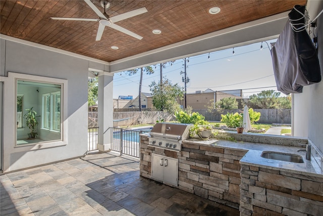 exterior space featuring area for grilling, ceiling fan, and sink