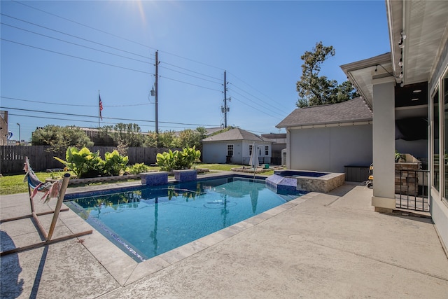 view of pool featuring an in ground hot tub, an outdoor structure, and a patio