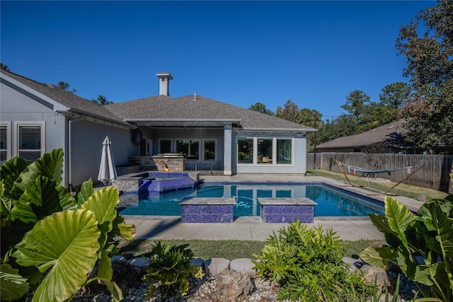 view of swimming pool with a patio area and an in ground hot tub