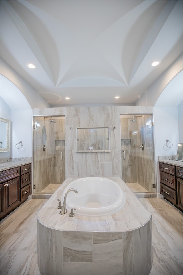 bathroom with separate shower and tub, vanity, and tile floors