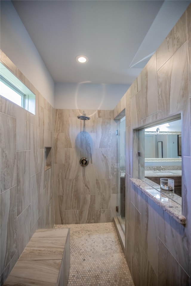 bathroom featuring sink and a tile shower