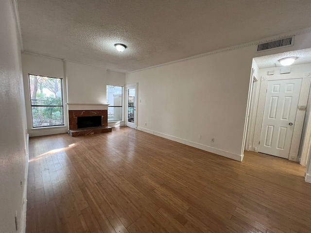 unfurnished living room featuring a textured ceiling and dark hardwood / wood-style flooring