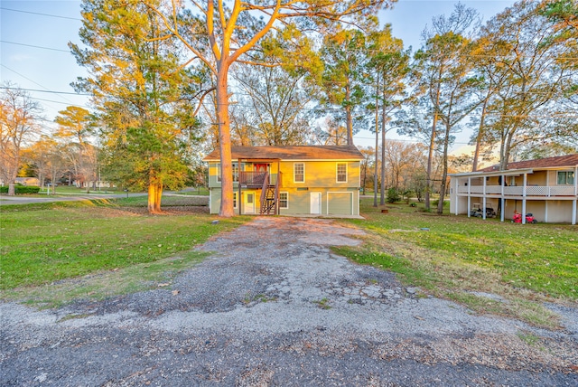 view of front of property with a front yard and a balcony