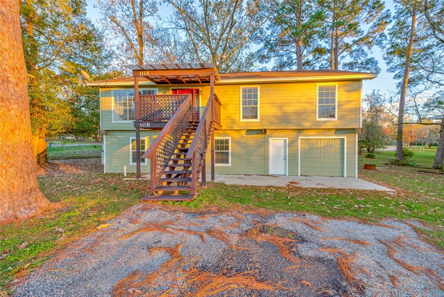 back of house featuring a pergola and a garage