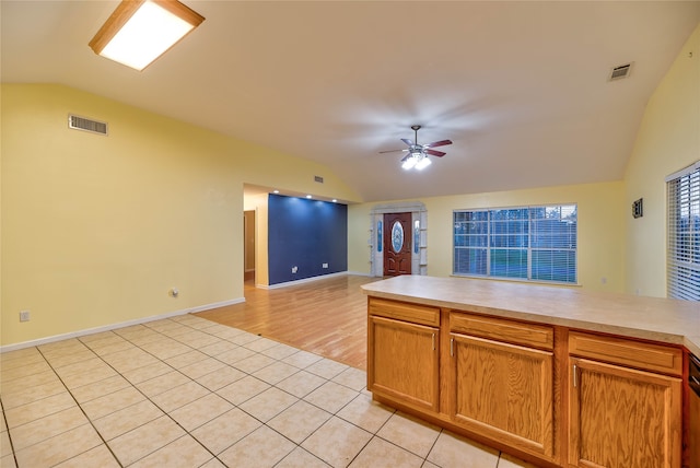 kitchen featuring light tile floors, lofted ceiling, and ceiling fan