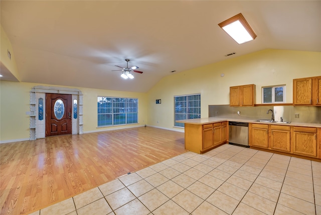 kitchen with kitchen peninsula, sink, ceiling fan, dishwasher, and light wood-type flooring