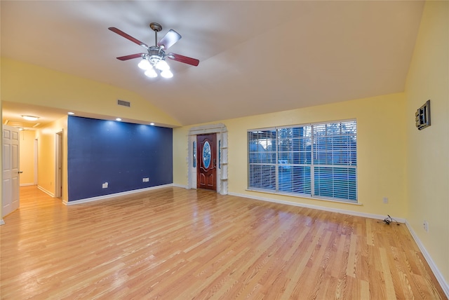 empty room with light hardwood / wood-style floors, ceiling fan, and vaulted ceiling