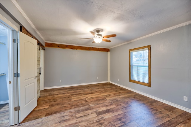 unfurnished room featuring ceiling fan, dark wood-type flooring, and ornamental molding