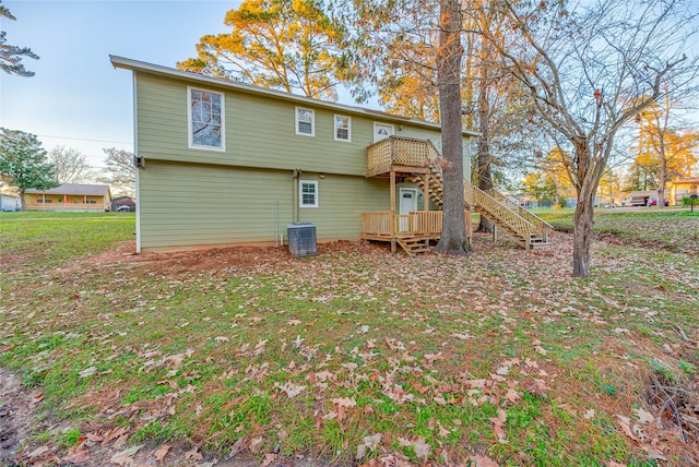 rear view of house with a deck and central air condition unit