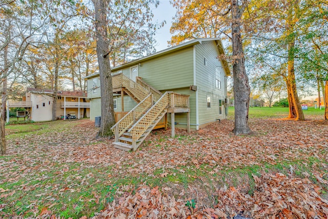 rear view of house featuring a wooden deck