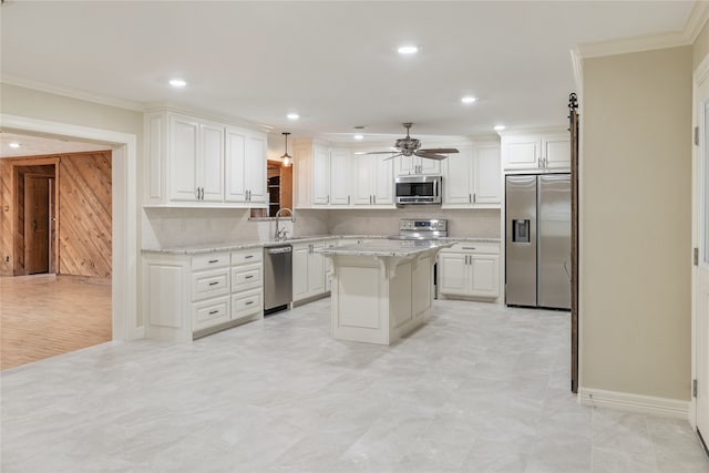 kitchen with ceiling fan, appliances with stainless steel finishes, a center island, and tasteful backsplash