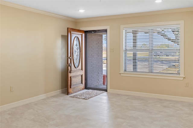 tiled foyer featuring ornamental molding