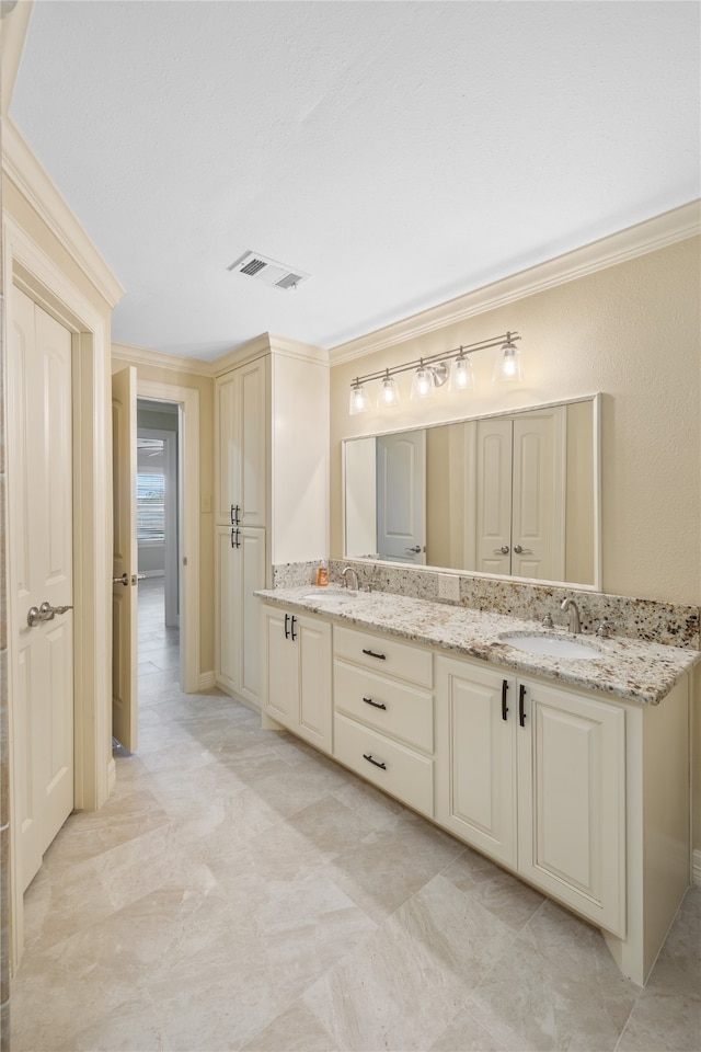 bathroom featuring crown molding, double sink vanity, and tile floors