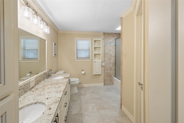 bathroom with double sink vanity, tile floors, crown molding, and toilet