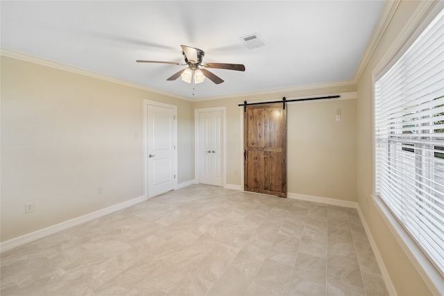 unfurnished bedroom featuring a barn door, light tile floors, ornamental molding, and ceiling fan