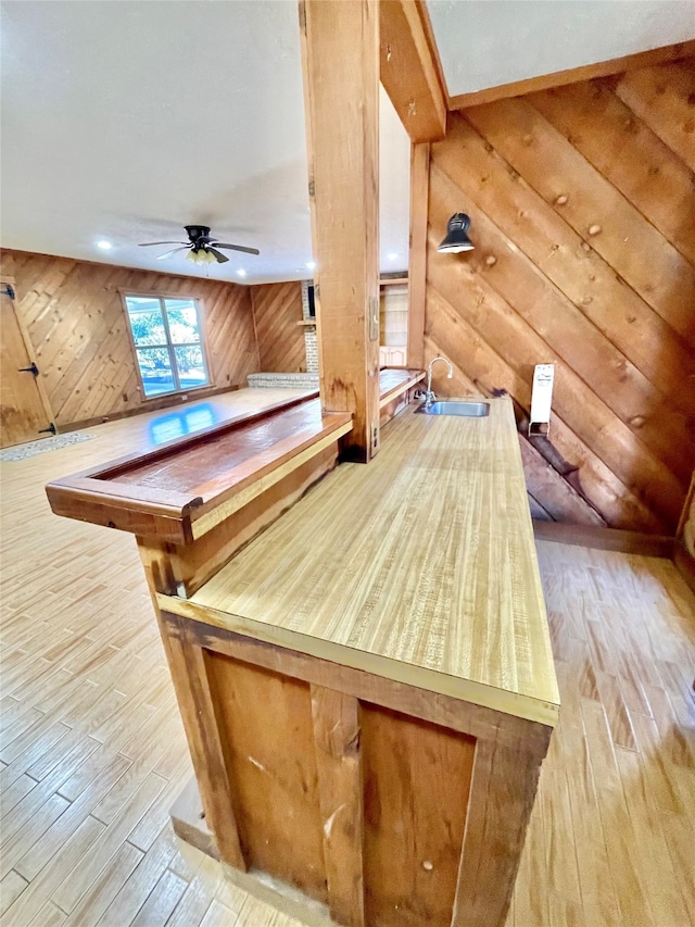 interior details featuring light hardwood / wood-style floors, ceiling fan, and sink