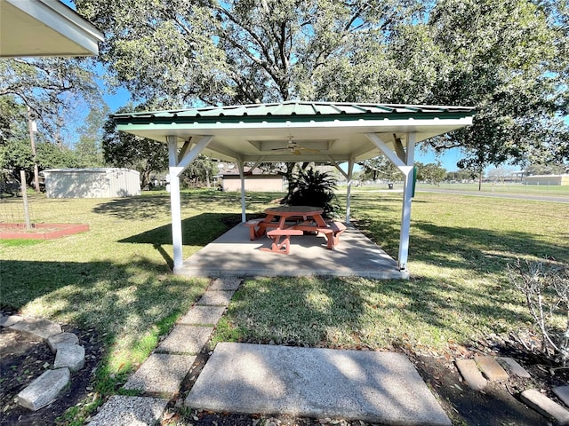 view of yard featuring a patio area and ceiling fan