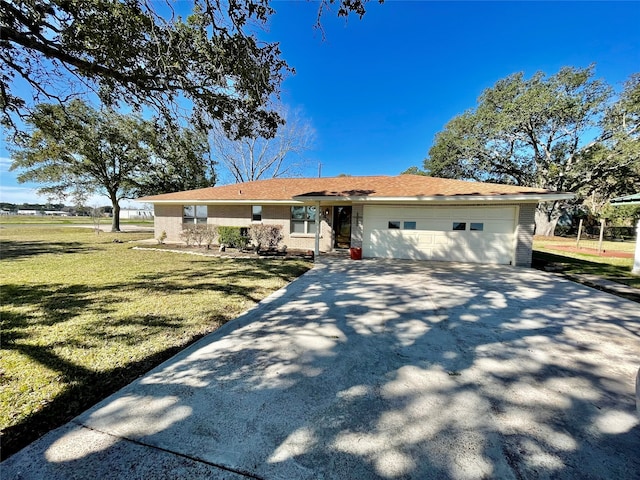 ranch-style house featuring a front yard and a garage