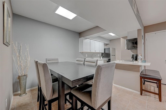 dining area with sink and light tile floors