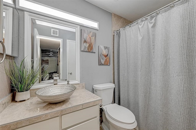 bathroom featuring toilet and vanity