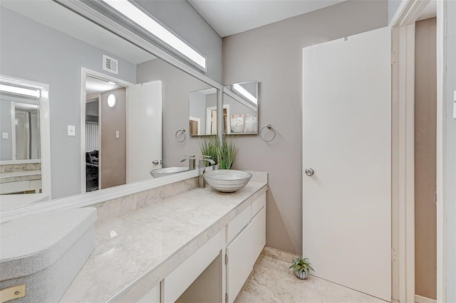 bathroom with tile flooring and vanity