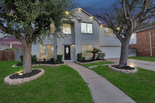 view of front of home featuring a yard and a garage