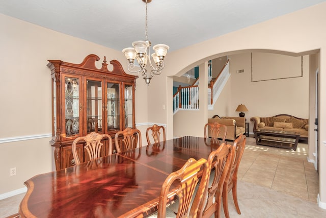 dining space featuring an inviting chandelier and light tile flooring